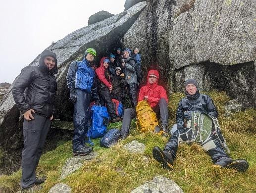 A group of people on a mountain
Description automatically generated with medium confidence