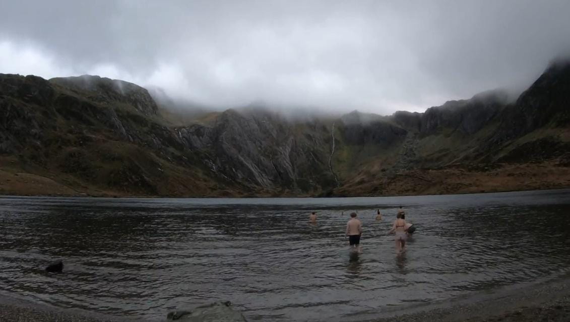 A group of people in a lake
Description automatically generated with medium confidence