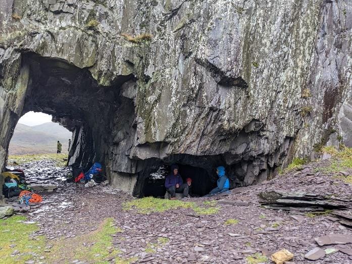 A group of people in a cave
Description automatically generated with medium confidence